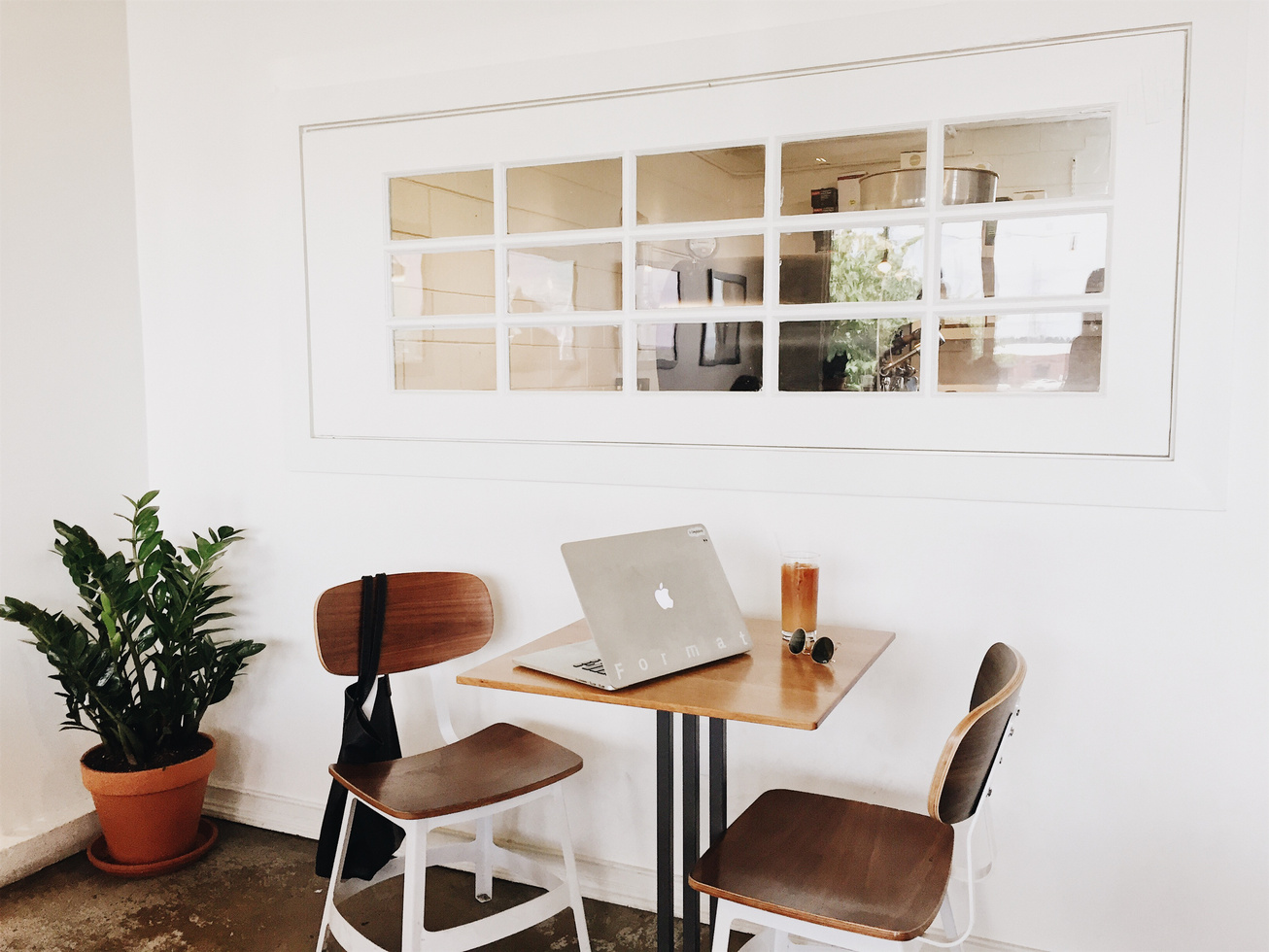 Macbook on Brown Wooden Dining Table and Chairs